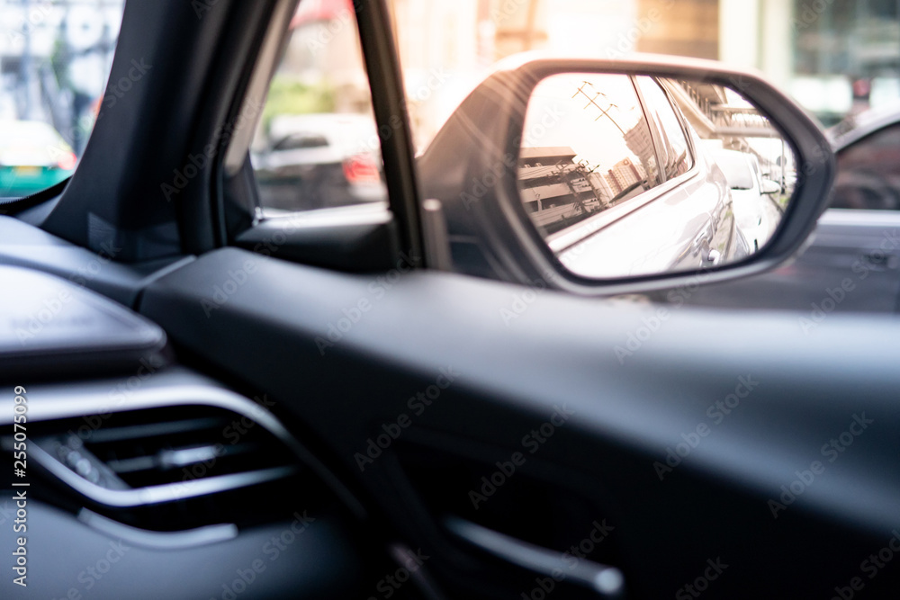 Reflection of modern car in metallic wing mirror from inside of the car. Auto transport design or automobile industry concepts