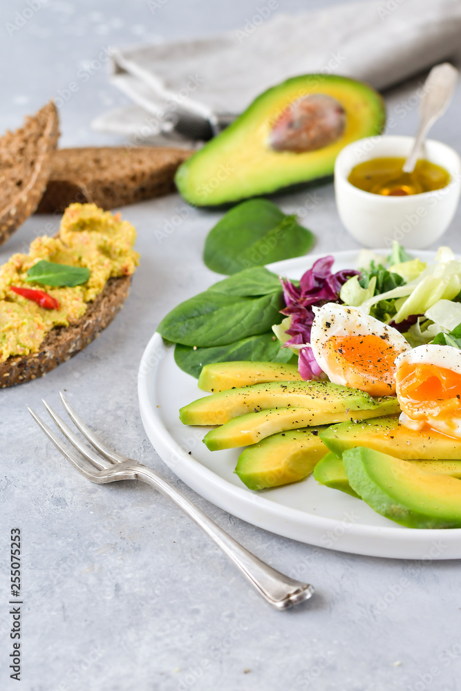 food for a healthy Breakfast or lunch. salad of avocado, kale leaves, egg and spinach, on a white plate, grain bread, diet food, organic vegetables, food flat lay food for a healthy Breakfast or lunch. salad of avocado, kale leaves, egg and spinach, on a white plate, grain bread, diet food, organic vegetables, food flat lay