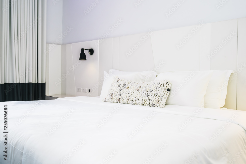White pillow on bed decoration in beautiful luxury bedroom interior