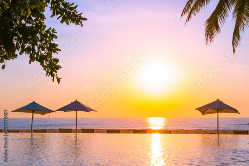 Fototapeta Naklejka Na Ścianę i Meble -  Beautiful landscape outdoor swimming pool with umbrella and deck chair in hotel resort for relax travel and vacation