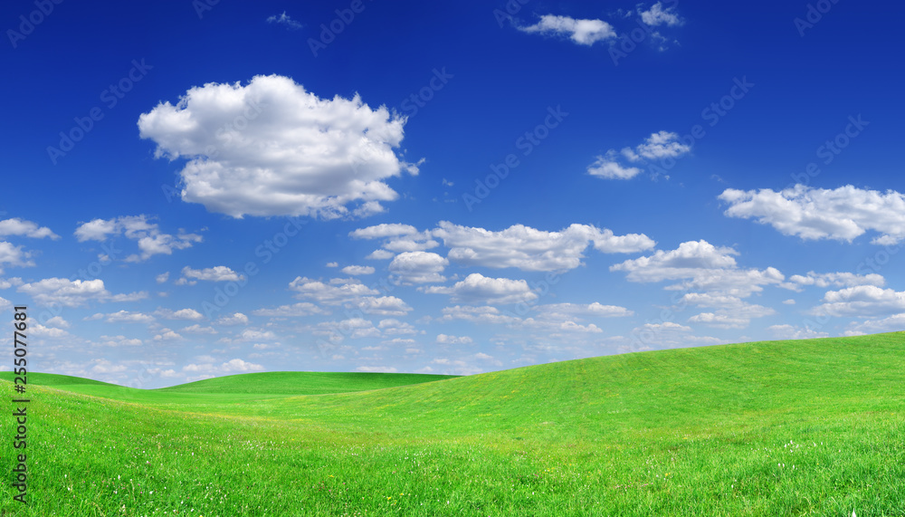 Idyllic view, green hills and blue sky with white clouds Idyllic view, green hills and blue sky with white clouds