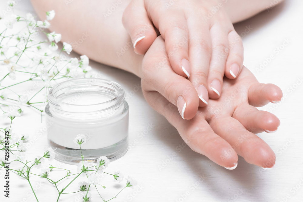 Fototapeta premium Cosmetic natural cream in a jar on a white table background.