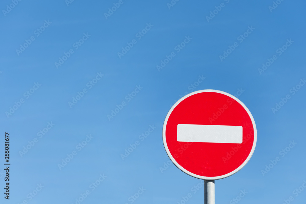 Round stop sign against a blue sky. Round stop sign against a blue sky.