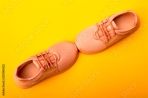 Wallpaper Mural Kid's fashion pink boots on color background. Stylish new shoes on yellow background. Torontodigital.ca