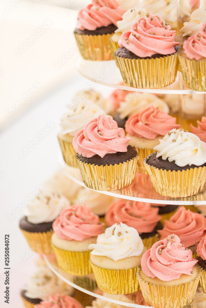 Pink and white cupcakes on a tier