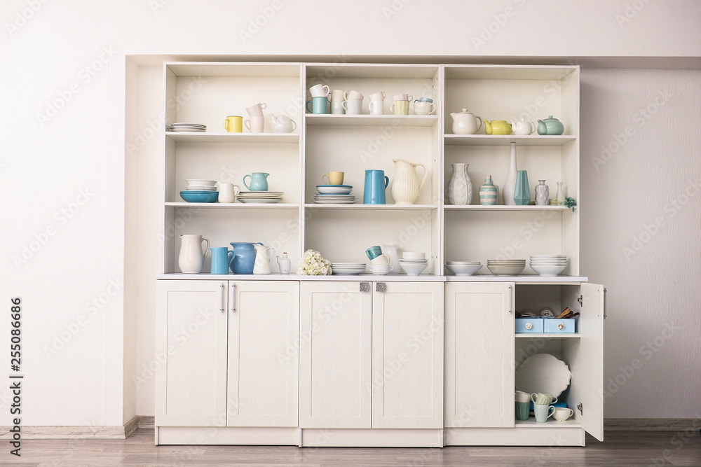 Cupboard with clean dishes in kitchen Cupboard with clean dishes in kitchen