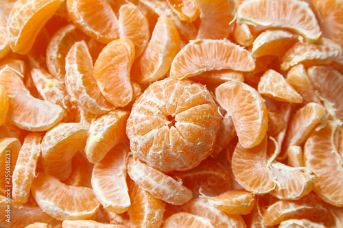 Peeled tangerine. Segments of mandarin fruit background