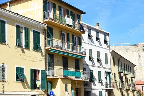 Southern italian street. Sunny houses with window shutters
