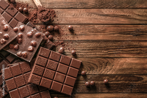 Sweet tasty chocolate on wooden background