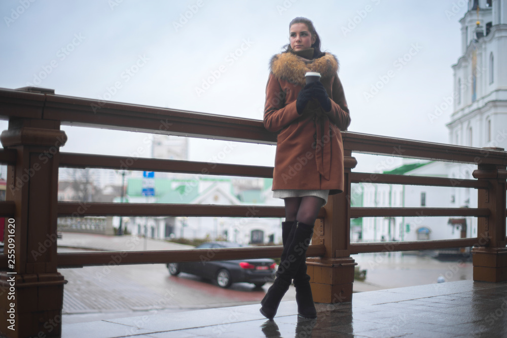 girl in a coat with coffee