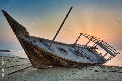 Sunset in Al Wakra beach capturing the wrecked dhow photo