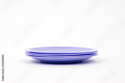 Plastic baby plates lilac color on a white background photo