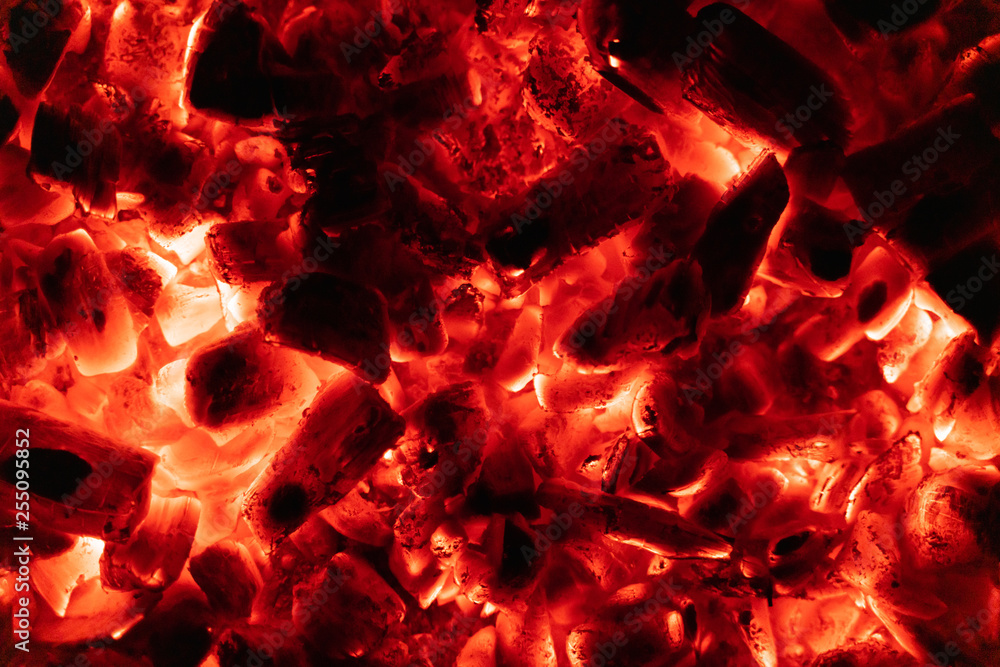 background glowing hot coals closeup. texture of burning coals