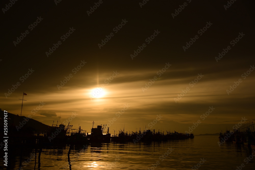 Fototapeta premium Fishing port view before sunset With beautiful golden yellow sky