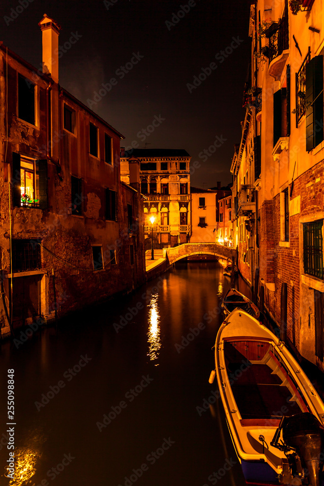 Long exposure. View of the canal and the bridge over it in Venice, Italy, at night.