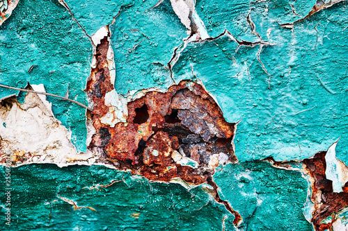 Background metal corrosion and cracking, scattering, corrosive, rusty pieces, green paint rusting closeup. photo
