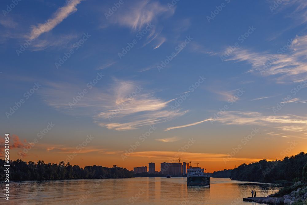 beautiful summer sunset with ship and city silhouettes