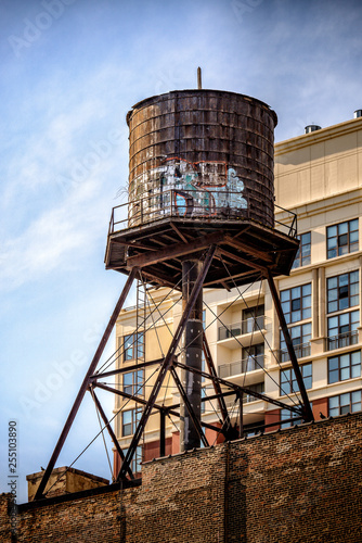 Old wood water tank with graffiti