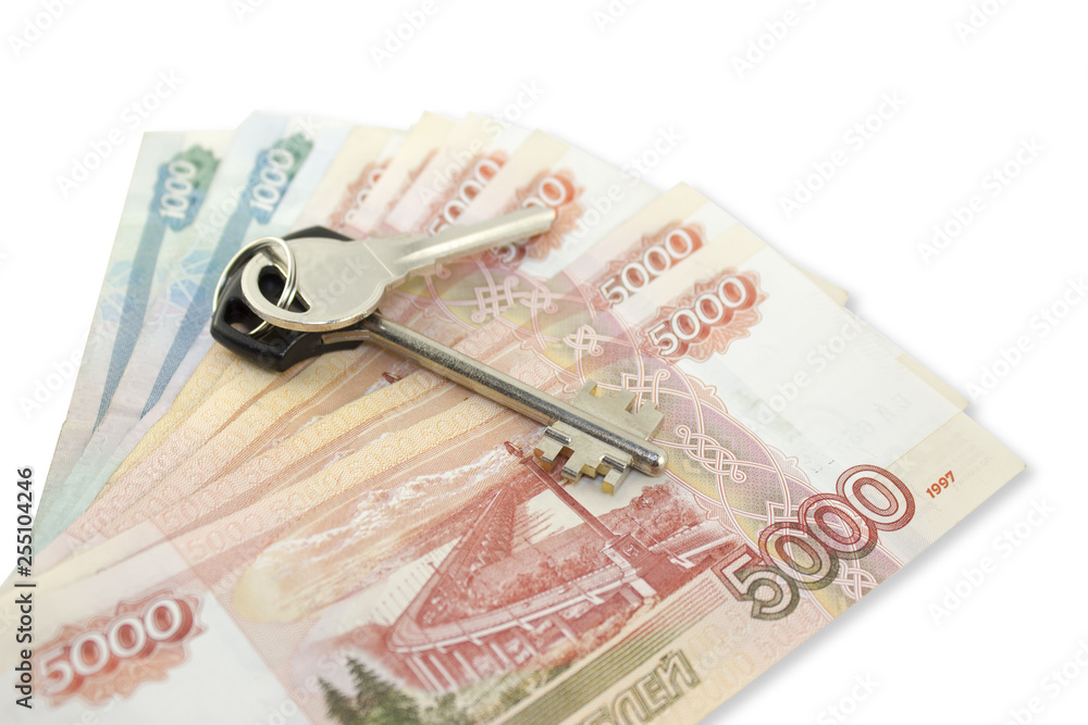 Metal keys on a horizontal background of a variety of banknotes of five and one thousand Russian rubles. Concept of buying an apartment, flat or house, mortgage. Metal keys on a horizontal background of a variety of banknotes of five and one thousand Russian rubles. Concept of buying an apartment, flat or house, mortgage.