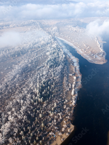 Aerial view of Volga river Bend and island with snowy trees in frost in Samara, Russia. © dimabucci