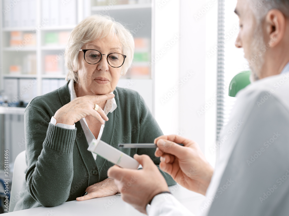 Professional doctor giving a prescription medicine to a senior patient Professional doctor giving a prescription medicine to a senior patient