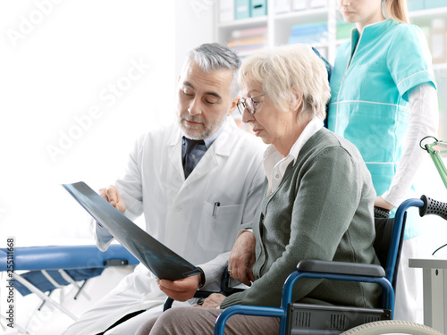 Radiologist checking an x-ray image with a senior patient photo