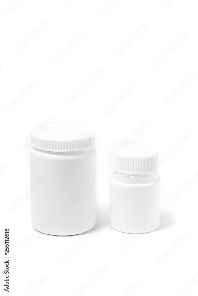 Two bottles of medicine white pills isolated on white Two bottles of medicine white pills isolated on white