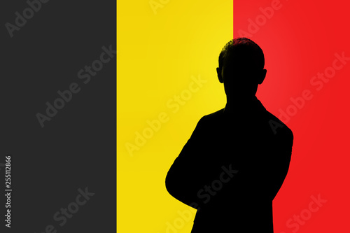 Silhouette of businessman on the background of the Belgian flag.
