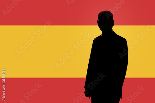 Silhouette of businessman on the background of the Spanish flag. Silhouette of a man, with space for text.