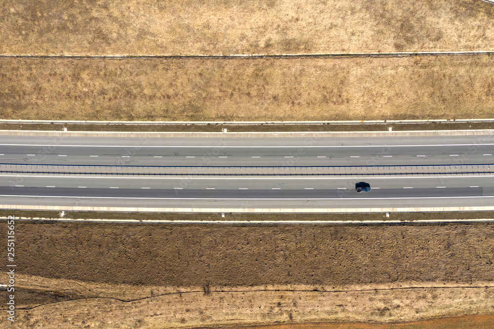 Aerial top view of cars and trucks passing on a highway