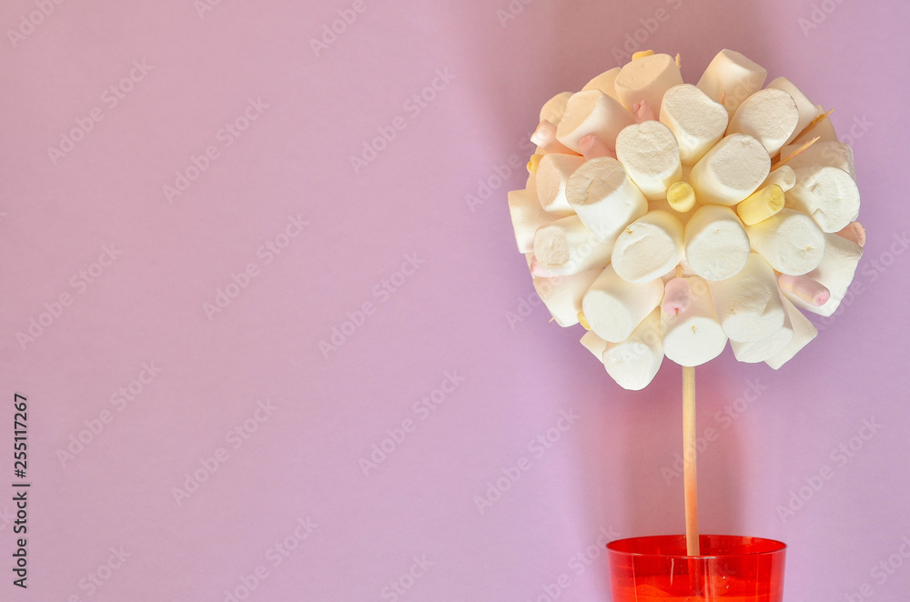 Tree made of marshmallows on pink color background Tree made of marshmallows on pink color background