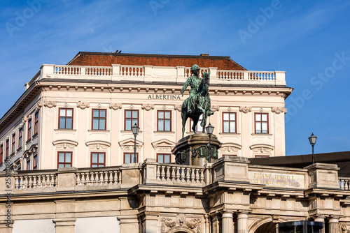 Austria, Vienna, Albrechtsplatz: Front view of world famous Albertina museum palais palace with Albrecht statue in the city center of the Austrian capital with blue sky - concept travel history art