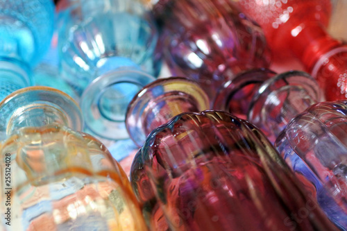 Background of ribbed colored glass flasks. coloured decorative glass 