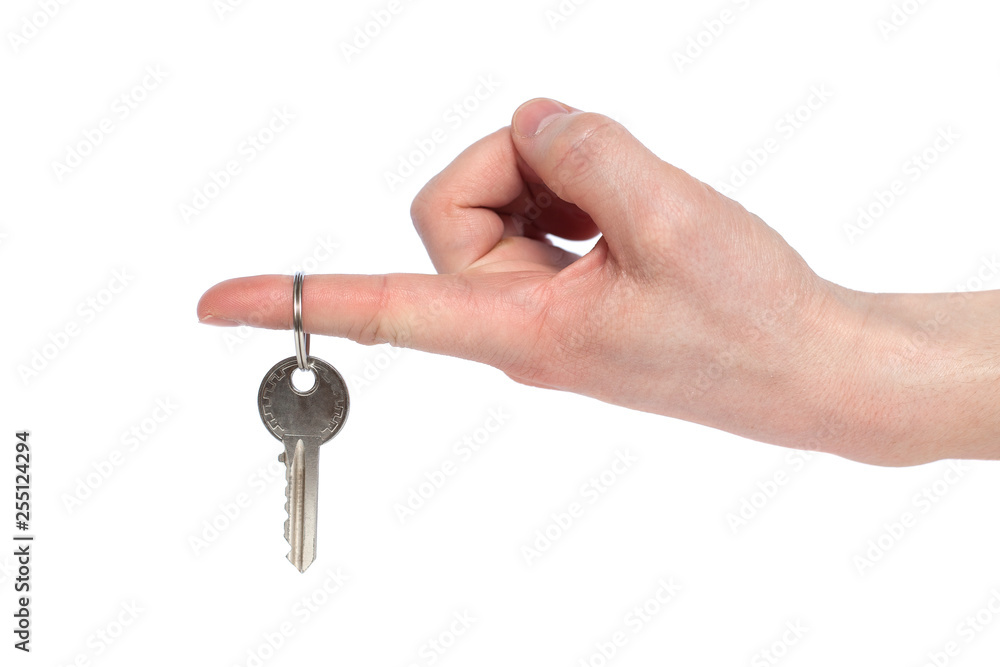 Human hand holding house key isolated on white background. Concept of new life and new home