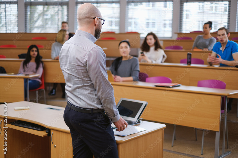 Lecturer and multinational group of students in an auditorium