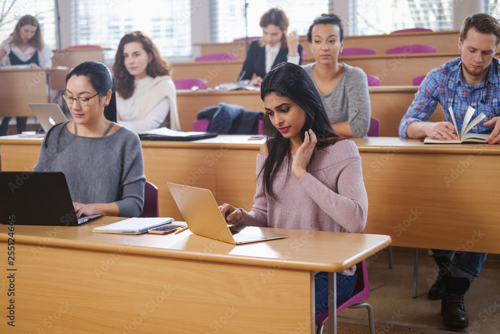 Multinational group of students in an auditorium Multinational group of students in an auditorium