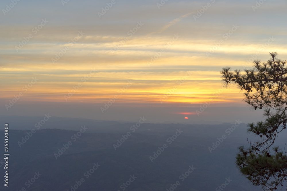 Silhouette of mountains with reflection in the sea. Sunset or sunrise background.