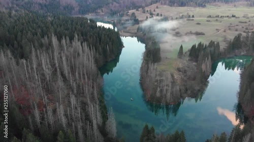 Aerial view of mysterious lake covered with fog