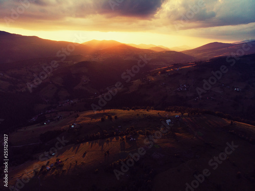 Sunset behind the peak in the mountains landscape