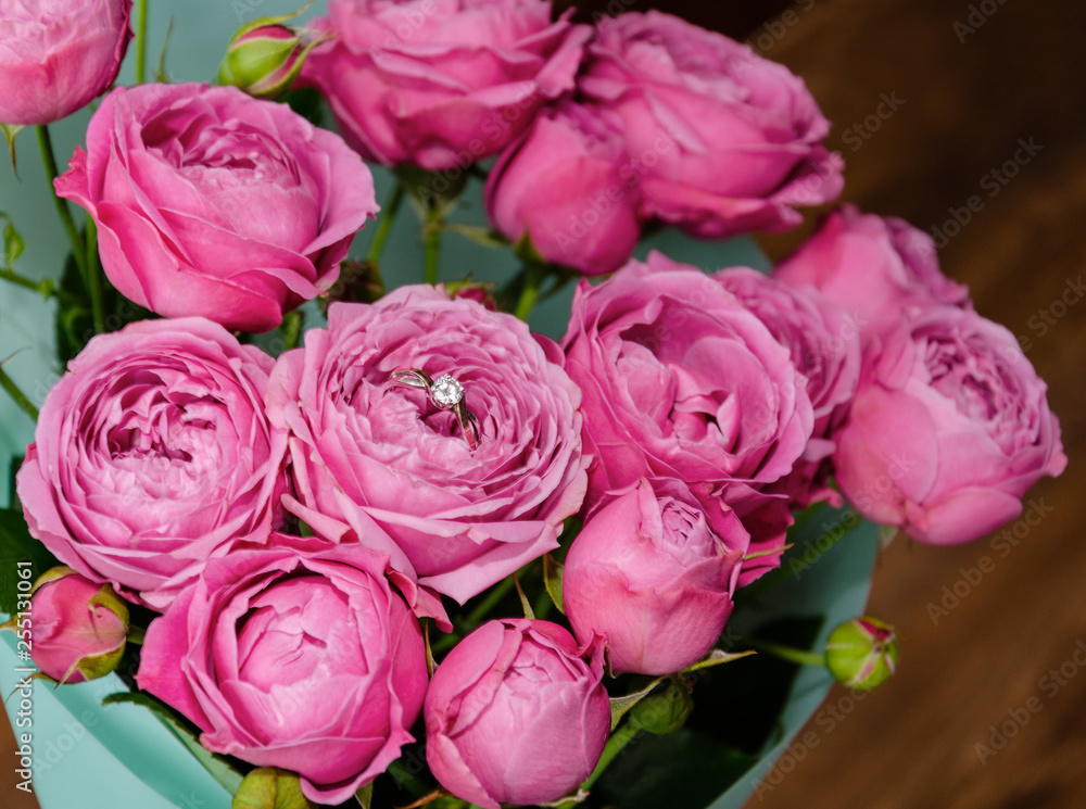 ring in a flower bouquet with pink roses ring in a flower bouquet with pink roses