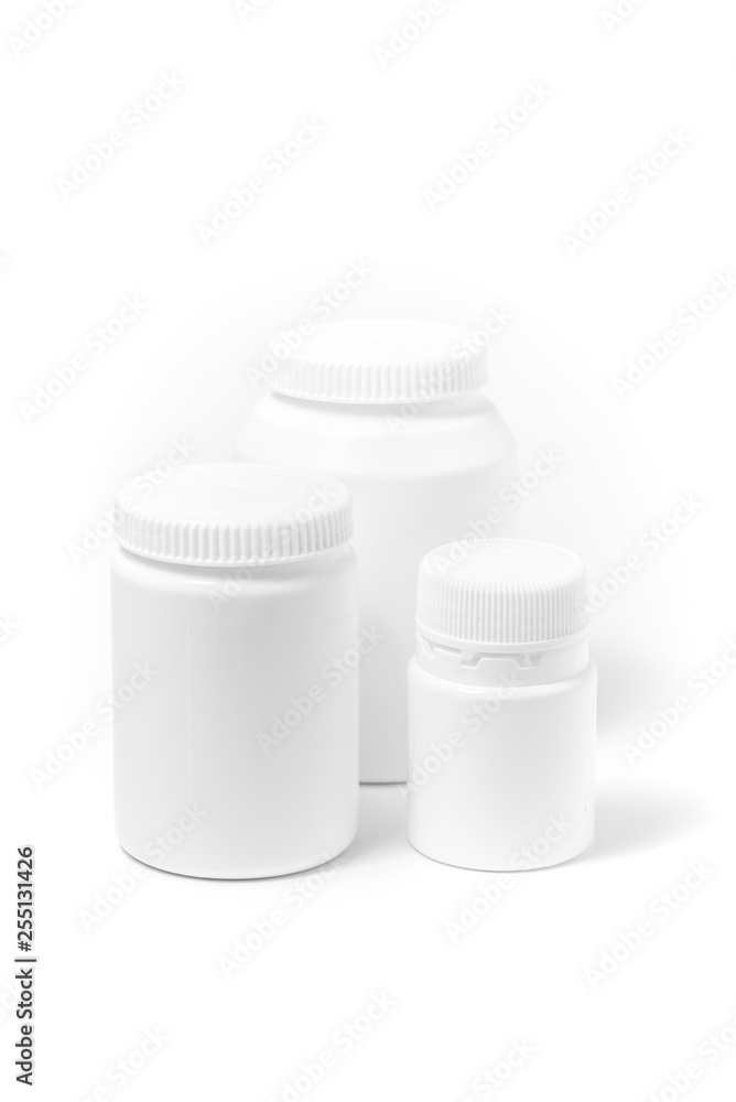 Three bottles of medicine white pills isolated on white Three bottles of medicine white pills isolated on white