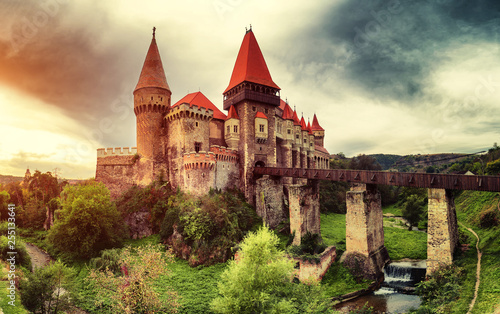 Beautiful view of castle with wooden bridge and high towers photo