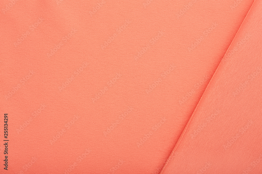 Fototapeta premium Pink cotton textile - close up of fabric texture. Cotton Fabric Texture. Top View of Cloth Textile Surface. Pink Clothing Background. Text Space. Abstract background and texture for designers.