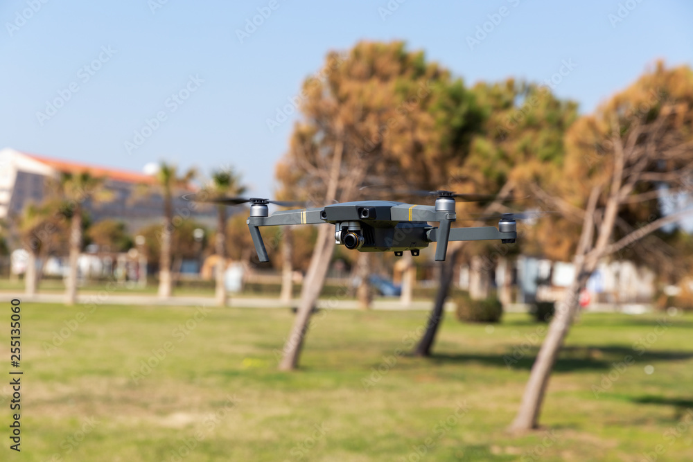 A drone with digital camera flying in the park