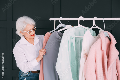 Senior fashion style. Shopping and clothing options. Elderly lady choosing outfit. photo