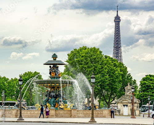 Fountain of the Seas (Fontaine des Mers) on place de la Concorde square with Eiffel tower at background, Paris, France photo