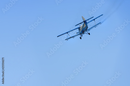 Airplane agricultural aircraft flying in the sky spraying mosquitoes