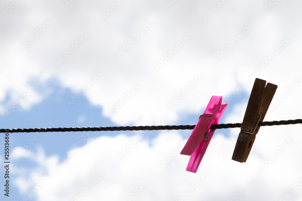 detail of two clothespins hanging on a rope detail of two clothespins hanging on a rope