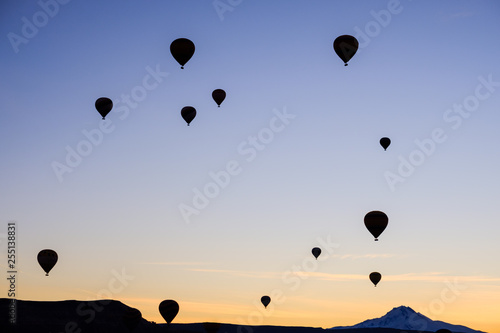 Silhouttes of hot air balloons in Cappadocia, Turkey, during sunrise