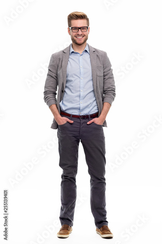 Full length portrait of young man standing on white background photo